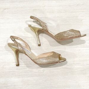 JIMMY CHOO: Gold Glitter Peeptoe Slingback Sandals. Comfortable 3.5" heel.